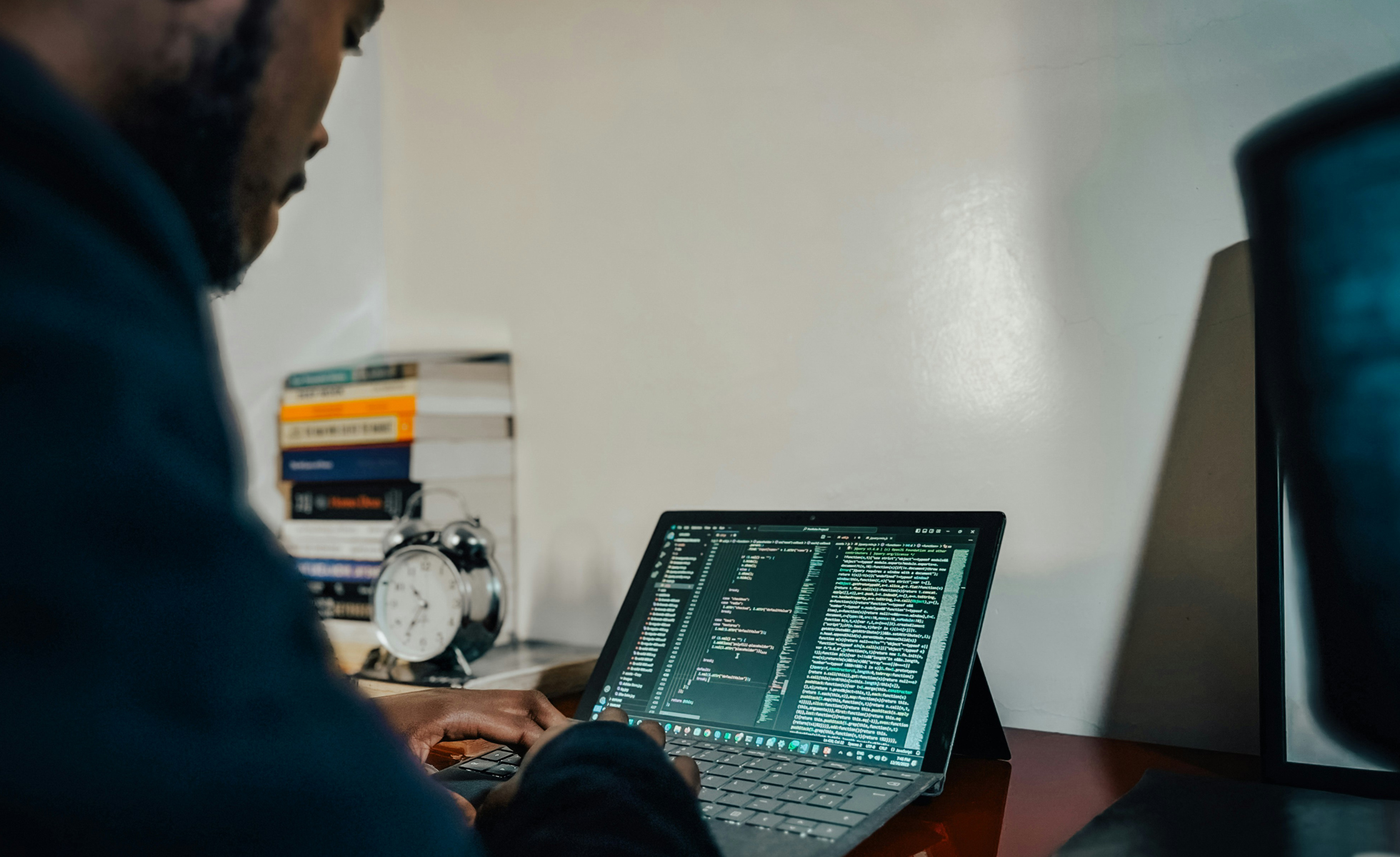 A man on a laptop. Photo by Hamidu Samuel Mansaray on Unsplash.