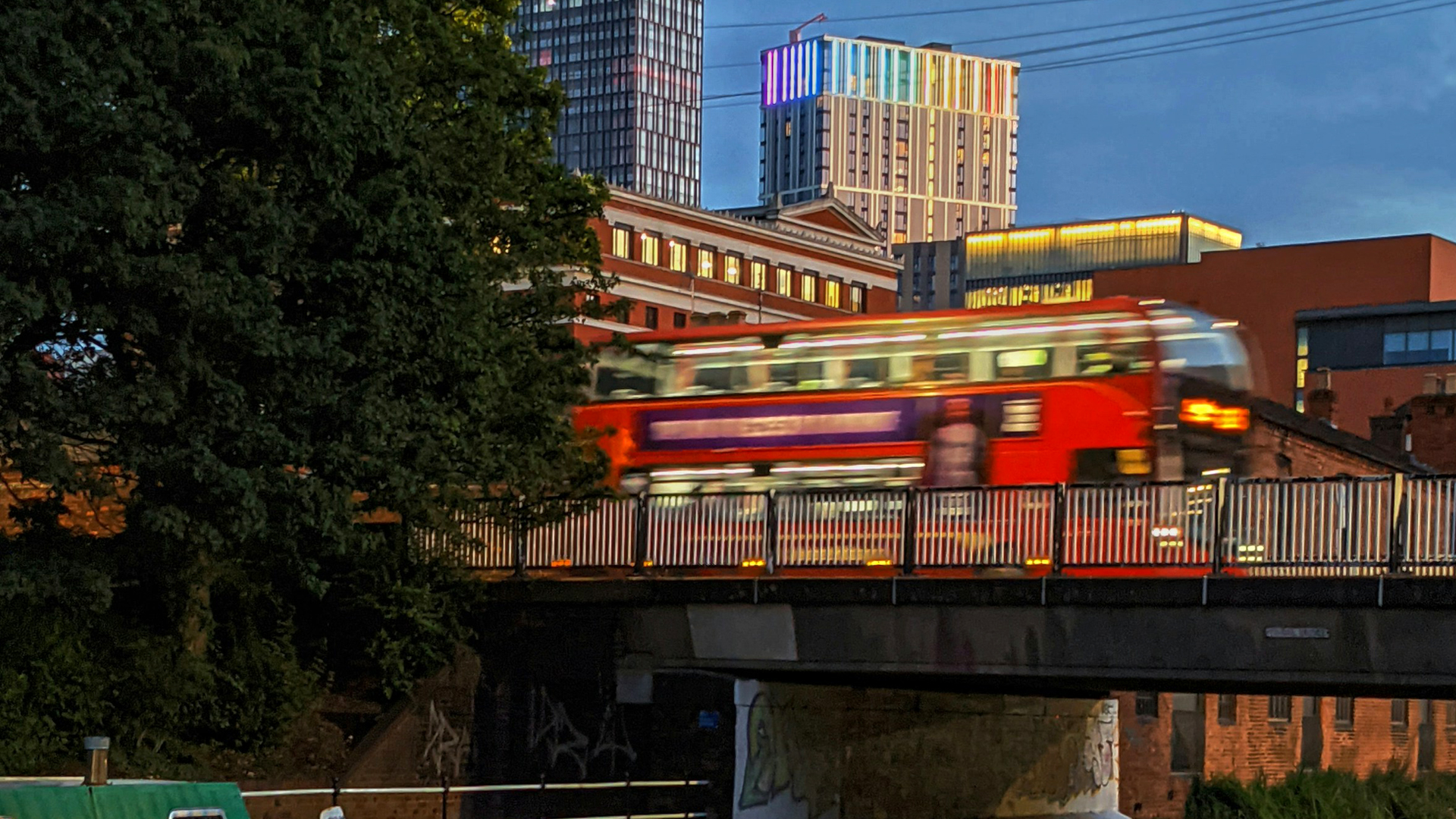 A bus crossing a bridge in Birmingham. Photo by Christian Mackie on Unsplash.