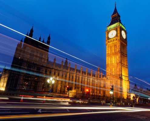 Traffic on Westminster Bridge passing Big Ben in London.